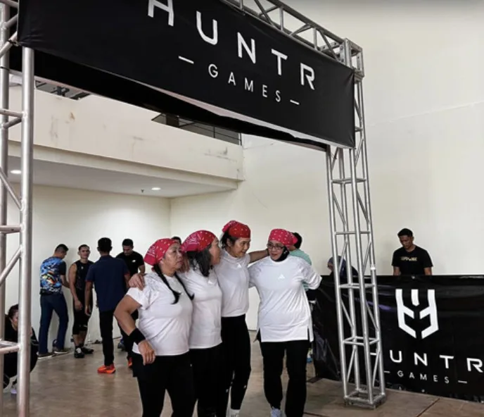 A team of women aged 60 and above at the HUNTR Games finish arch